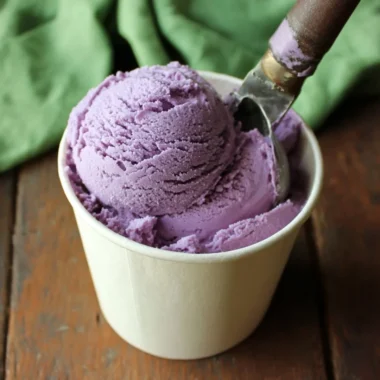 Delicious homemade blueberry ice cream served in a bowl with fresh blueberries