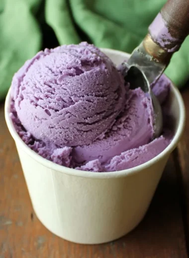 Delicious homemade blueberry ice cream served in a bowl with fresh blueberries
