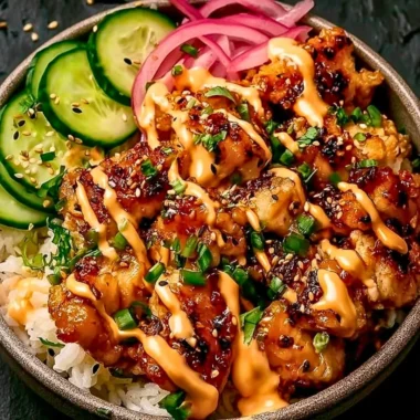 Creamy spicy chicken served over jasmine rice in a bowl