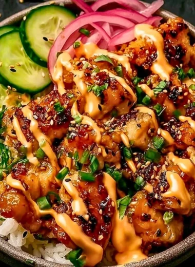 Creamy spicy chicken served over jasmine rice in a bowl