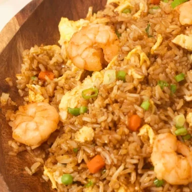 Plate of homemade Chinese shrimp fried rice with vegetables and spices