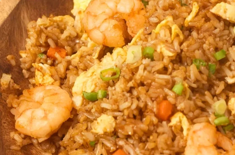 Plate of homemade Chinese shrimp fried rice with vegetables and spices