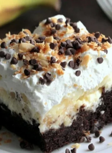 Delicious Chocolate Banana Poke Cake topped with chocolate glaze and banana slices.