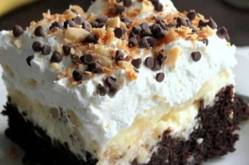Delicious Chocolate Banana Poke Cake topped with chocolate glaze and banana slices.
