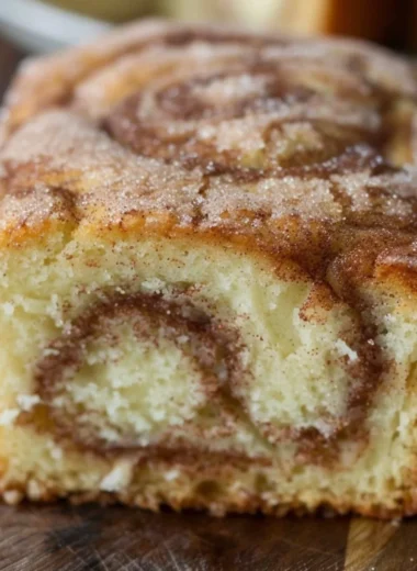Freshly baked cinnamon swirl donut bread with a rich cinnamon topping