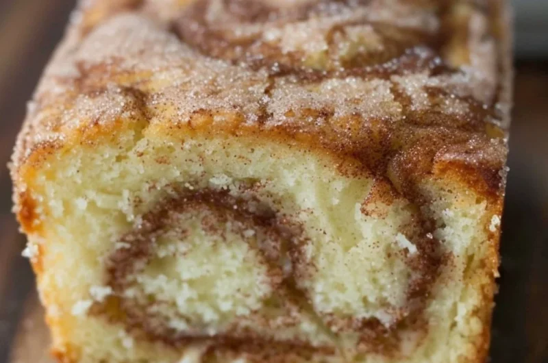 Freshly baked cinnamon swirl donut bread with a rich cinnamon topping