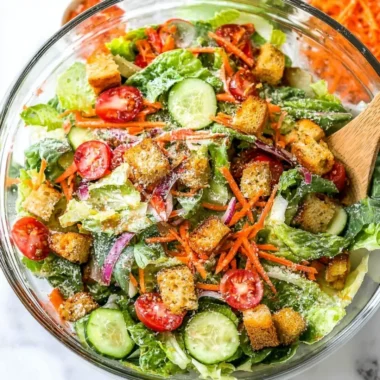 Classic house salad with fresh vegetables and dressing served in a bowl