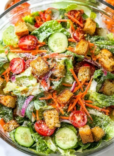 Classic house salad with fresh vegetables and dressing served in a bowl