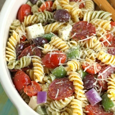 Bowl of classic pasta salad with colorful vegetables and dressing