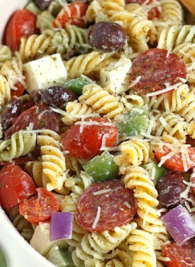 Bowl of classic pasta salad with colorful vegetables and dressing