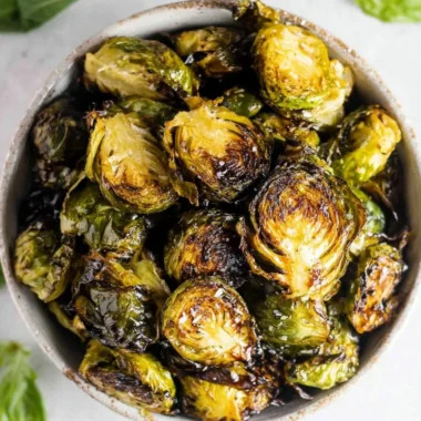Crispy oven roasted Brussels sprouts with balsamic glaze served on a plate