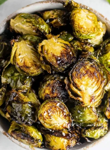 Crispy oven roasted Brussels sprouts with balsamic glaze served on a plate