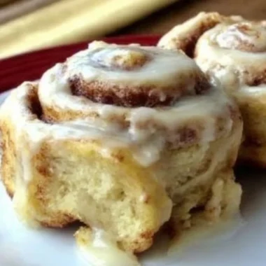 Freshly baked homemade cinnamon rolls with icing on a plate