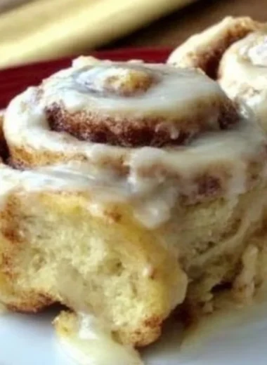 Freshly baked homemade cinnamon rolls with icing on a plate