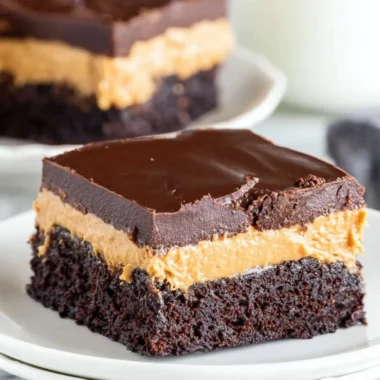 Delicious layered peanut butter brownies topped with chocolate icing.