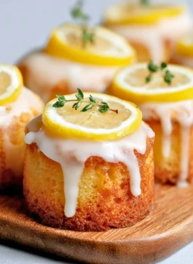 Mini lemon drizzle cakes garnished with zest and icing