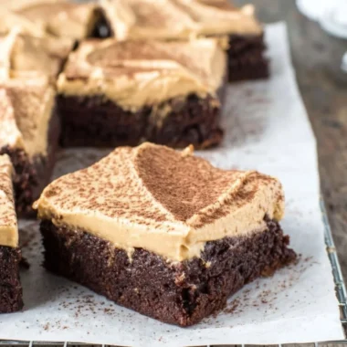 Mocha Brownies topped with Cafe Latte Frosting on a decorative plate