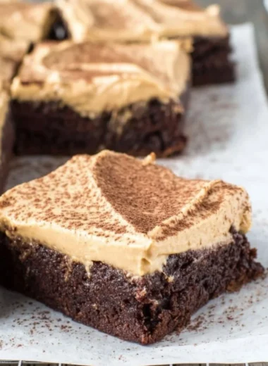 Mocha Brownies topped with Cafe Latte Frosting on a decorative plate