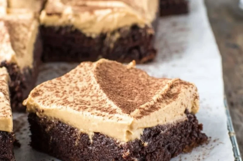 Mocha Brownies topped with Cafe Latte Frosting on a decorative plate