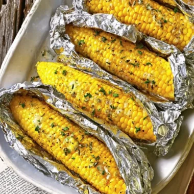Oven-roasted corn on the cob served on a rustic plate