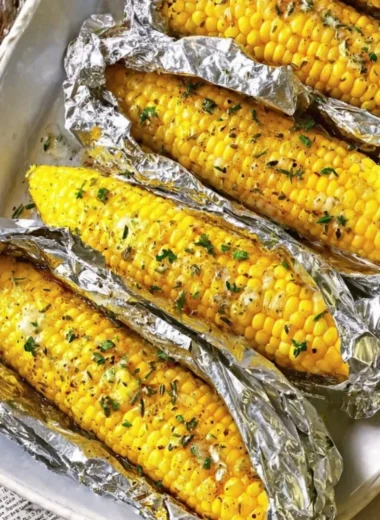 Oven-roasted corn on the cob served on a rustic plate