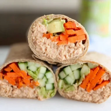 Delicious spicy tuna wraps on a plate garnished with fresh vegetables.