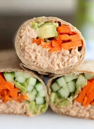 Delicious spicy tuna wraps on a plate garnished with fresh vegetables.