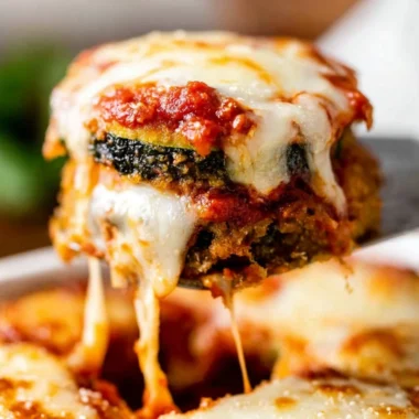 Baked Zucchini Parmesan with golden melted cheese and herbs
