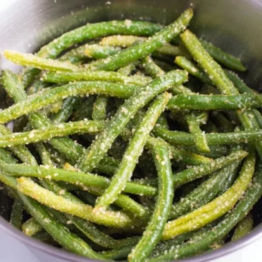 Air Fryer Parmesan Green Beans garnished with parmesan cheese and herbs