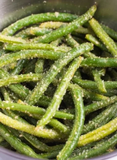 Air Fryer Parmesan Green Beans garnished with parmesan cheese and herbs