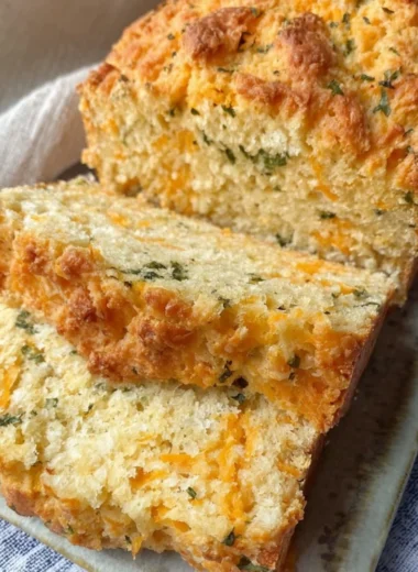 Freshly baked Cheddar Bay Biscuit Bread served on a wooden platter.