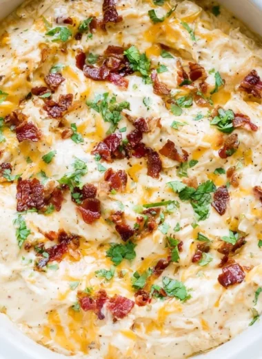 Delicious bowl of creamy Crack Chicken topped with herbs