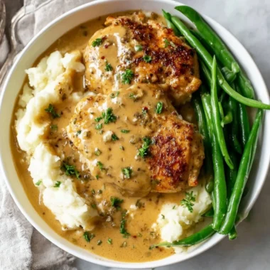 Delicious creamy garlic chicken served on a plate with herbs.