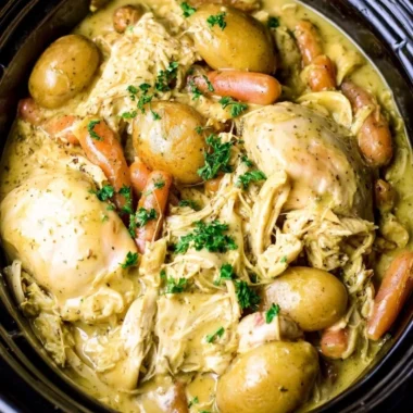 Crockpot ranch chicken served with fresh vegetables in a cozy dish