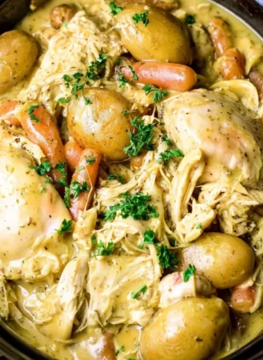 Crockpot ranch chicken served with fresh vegetables in a cozy dish