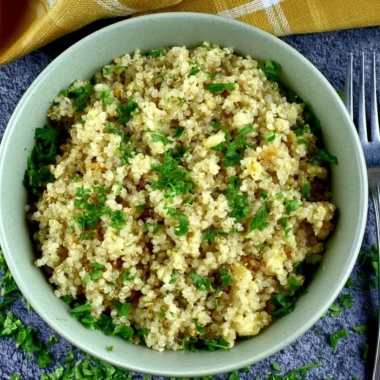 Delicious garlic butter quinoa served in a bowl with herbs