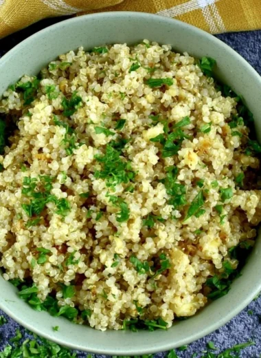 Delicious garlic butter quinoa served in a bowl with herbs