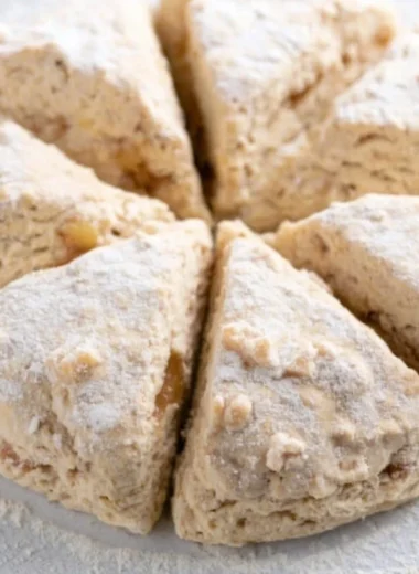 Freshly baked spiced apple scones with a golden crust and apple chunks