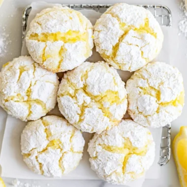 Plate of freshly baked Lemon Crinkle Cookies dusted with powdered sugar