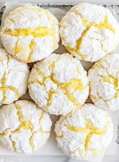 Plate of freshly baked Lemon Crinkle Cookies dusted with powdered sugar
