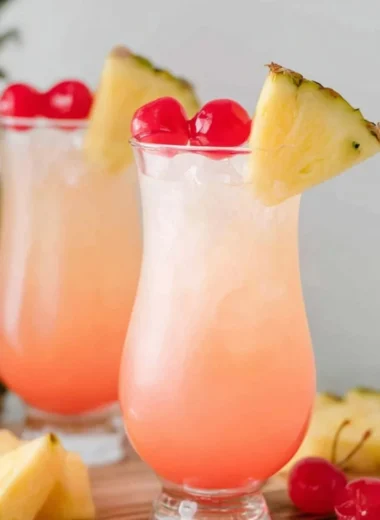 Refreshing Malibu Bay Breeze cocktail served in a glass with tropical fruits.