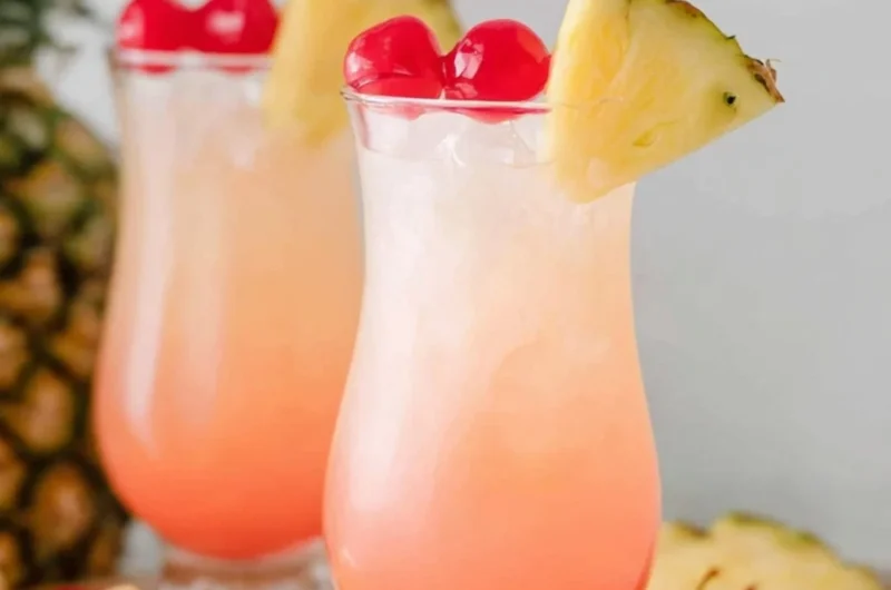 Refreshing Malibu Bay Breeze cocktail served in a glass with tropical fruits.