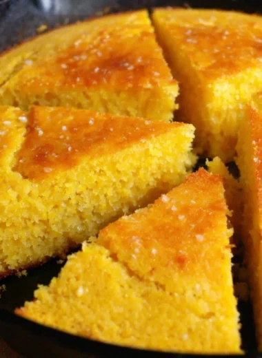 Slice of old-fashioned cornbread served on a wooden plate