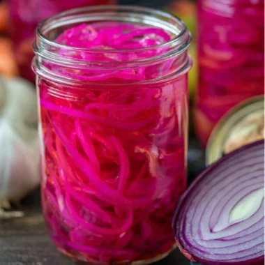 Quickly pickled red onions in a jar, perfect for enhancing meals with flavor.