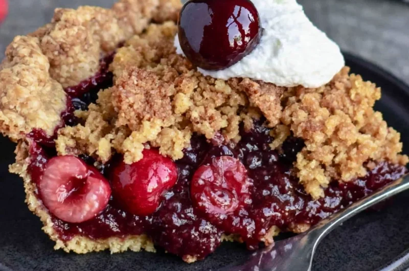 Freshly baked Cherry Crumb Pie with a golden crumble topping and vibrant cherry filling