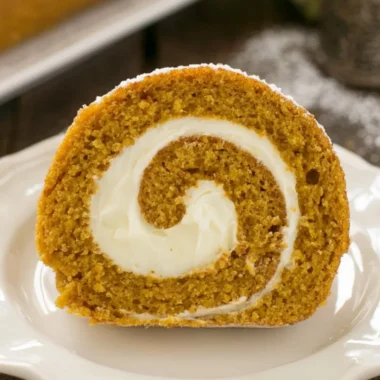 A delicious Classic Pumpkin Roll with cream filling and dusted with powdered sugar.