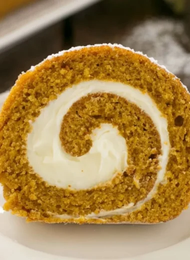 A delicious Classic Pumpkin Roll with cream filling and dusted with powdered sugar.
