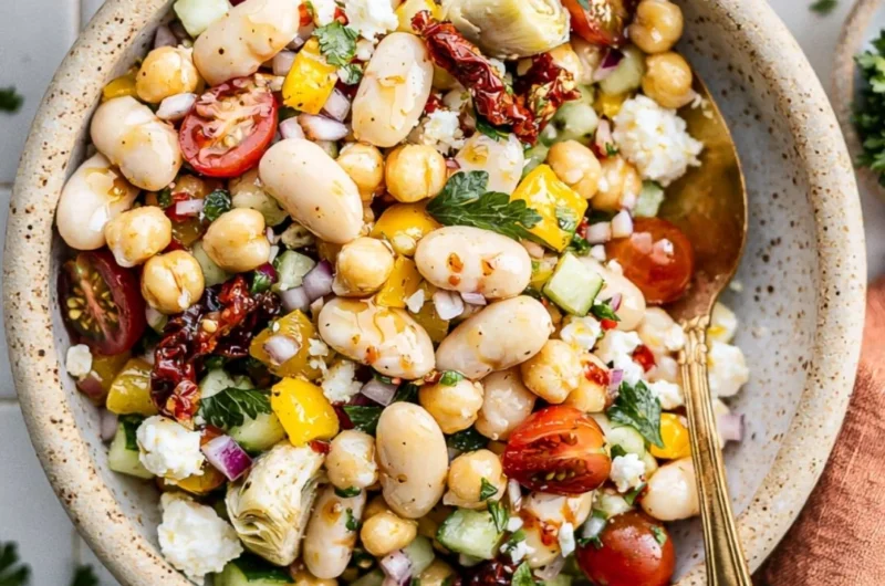 Colorful dense bean salad with a variety of beans and fresh vegetables