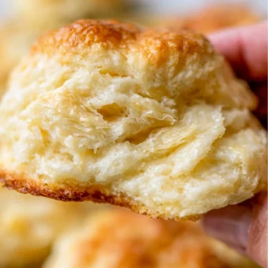 A tray of fluffy homemade biscuits fresh out of the oven.