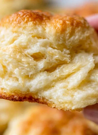 A tray of fluffy homemade biscuits fresh out of the oven.